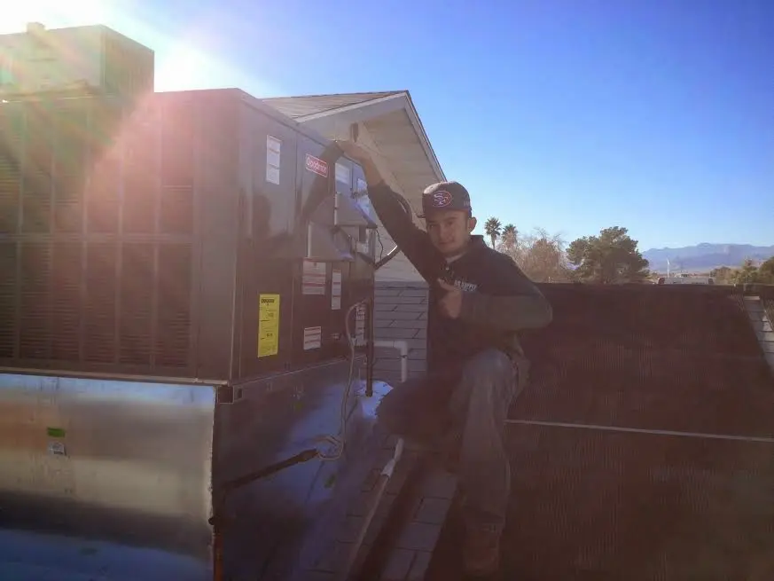 HVAC technician performing Boiler Repair on a rooftop unit in Camp Pendleton South